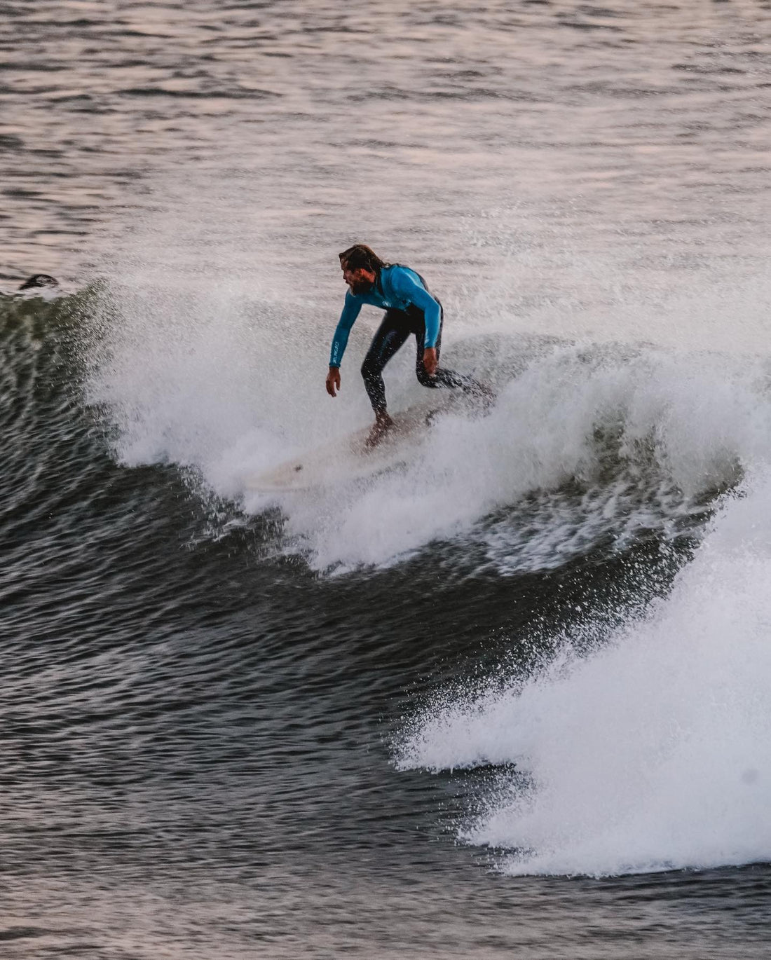 Limestone wetsuit vs neoprene. Two paddle boarders wearing their limestone wetsuits.